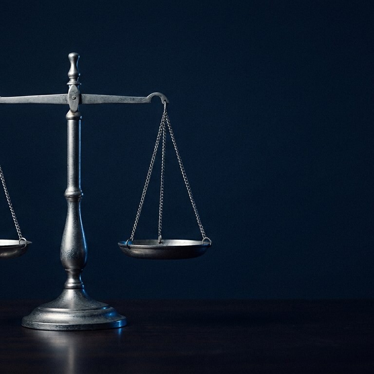 Silver balance scale on a dark surface